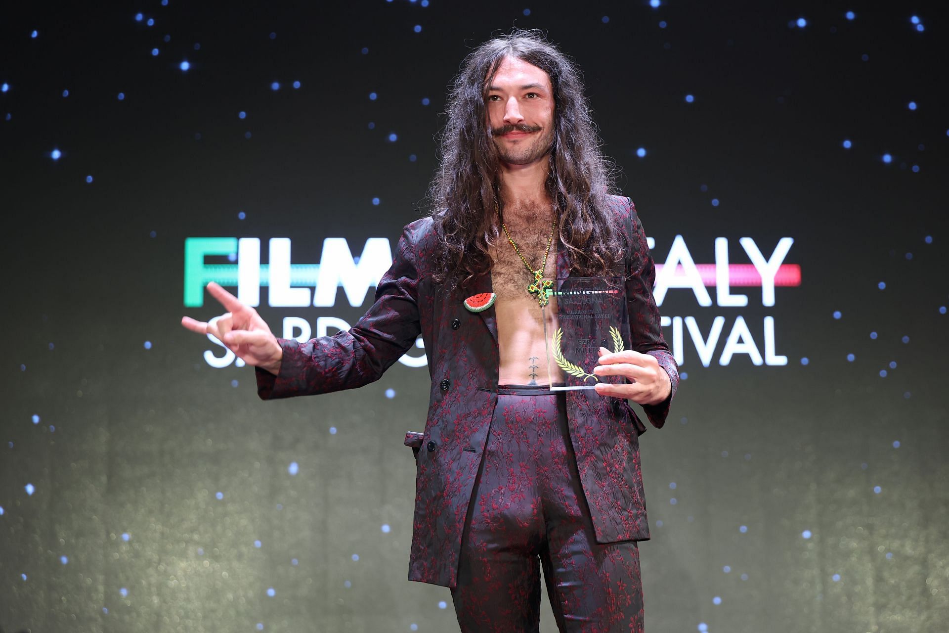 Miller is seen on stage after the Filming Italy 2025 red carpet at Forte Village Resort. (Image via Getty)